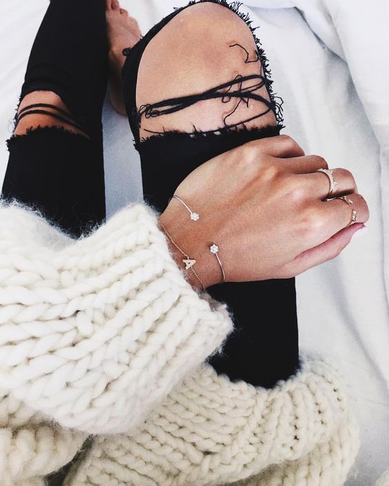 Chunky sweater with delicate bracelets