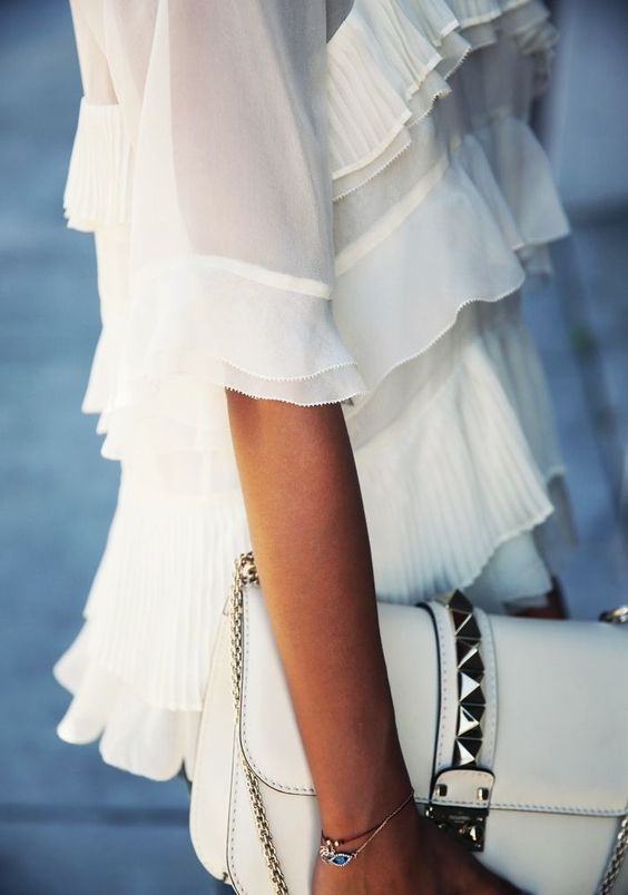 White flowy outfits and dainty bracelets